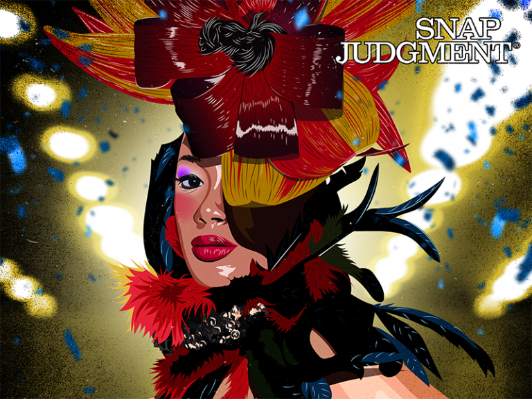 A woman with incredible hair is looking at the viewer. Her hair is shaped into a flower with red and yellow feathers.