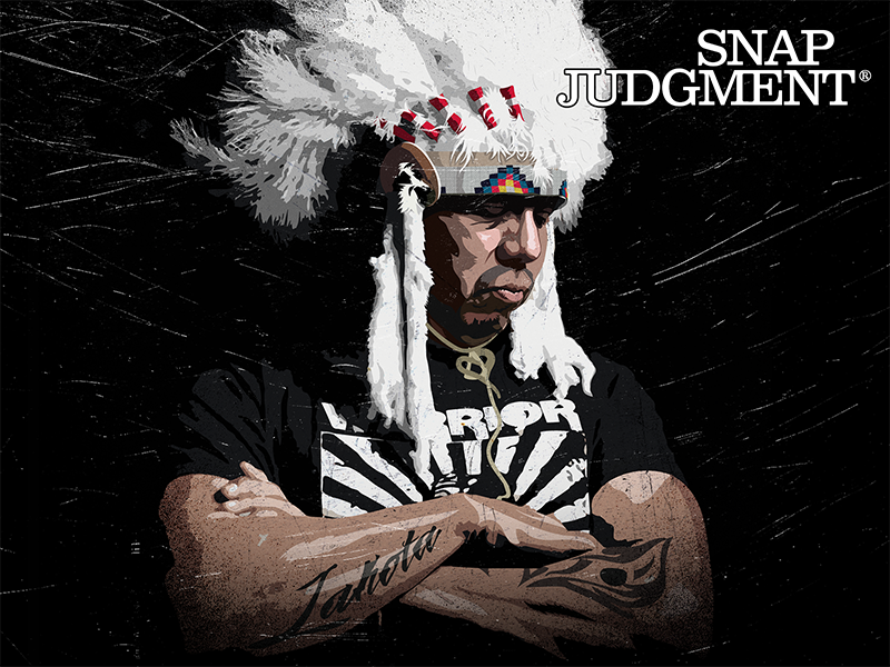 An Oglala Lakota Headsman wearing a headdress with his arms crossed.