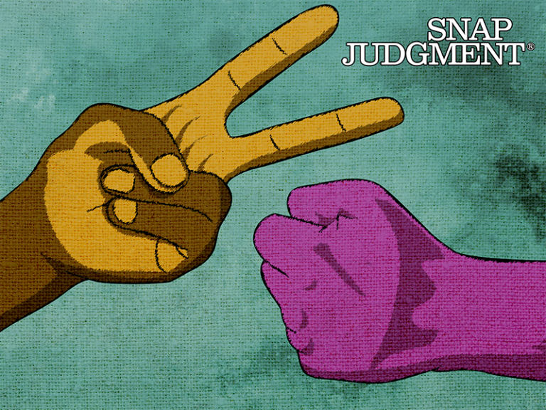 Two hands engaged in a game of rock paper scissors. One hand is holding 'scissors' up, the other 'rock'.