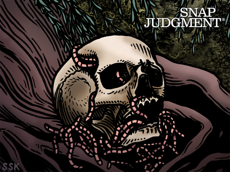 A skull is full of worms sitting under a tree.