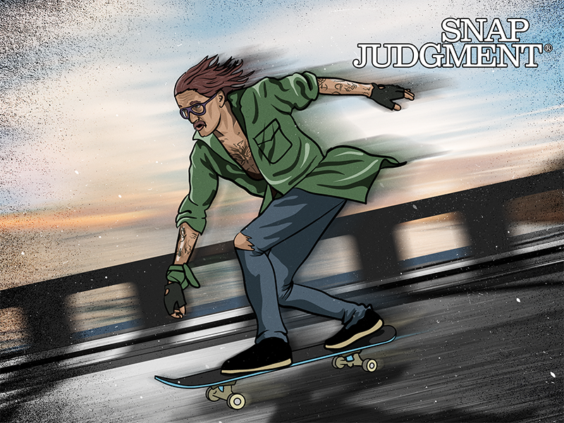 A man is skateboarding down a hill. His hair is blowing in the wind as he skates.
