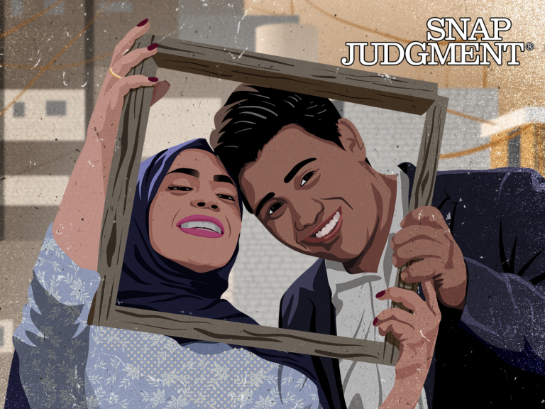 A couple is smiling holding a wooden frame around their faces. They are taking engagement photos.